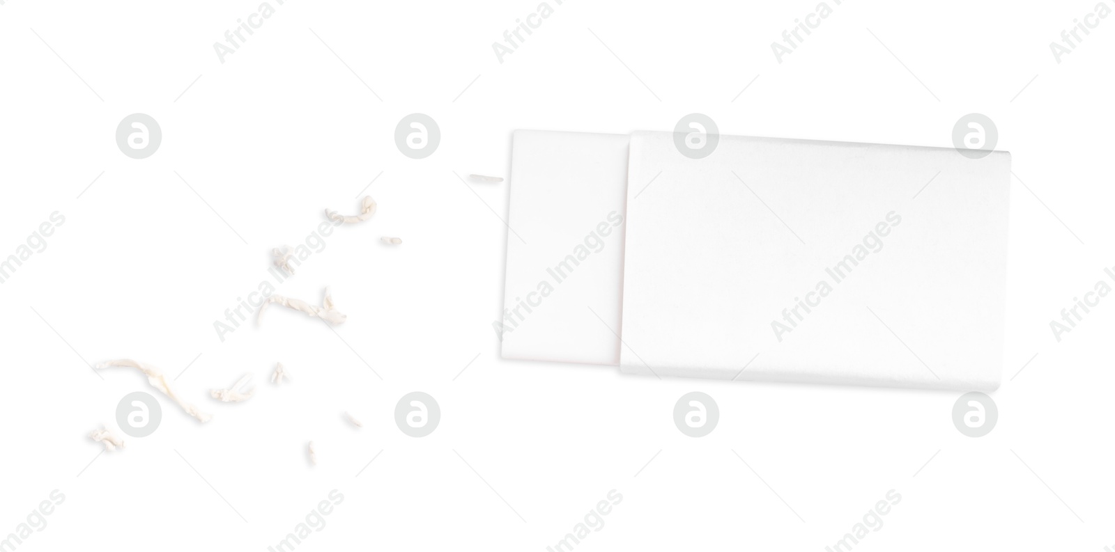 Photo of One eraser and scraps isolated on white, top view