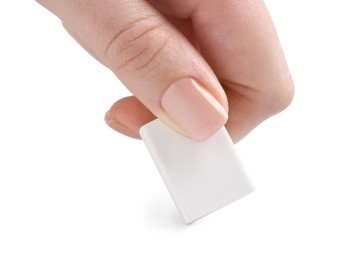 Photo of Woman using eraser on white background, closeup