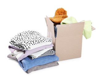 Photo of Box with different used clothes isolated on white