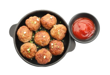 Photo of Tasty meatballs with green onion in baking dish and tomato sauce isolated on white, top view