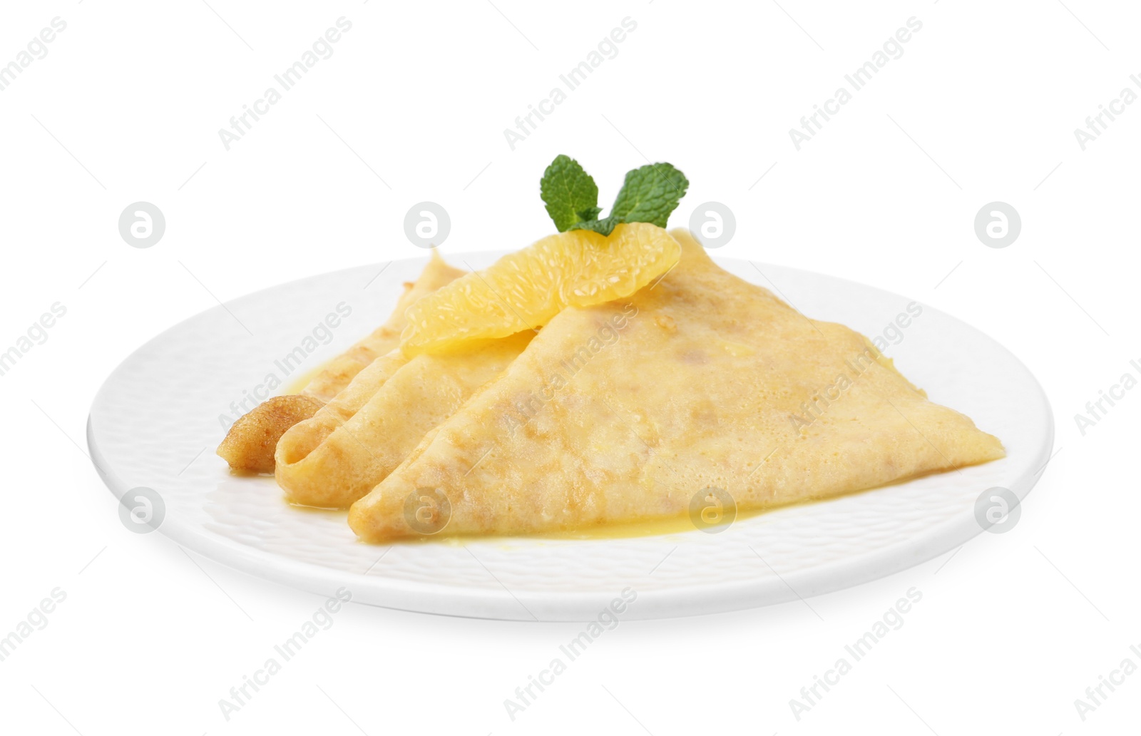 Photo of Plate with tasty crepes Suzette isolated on white