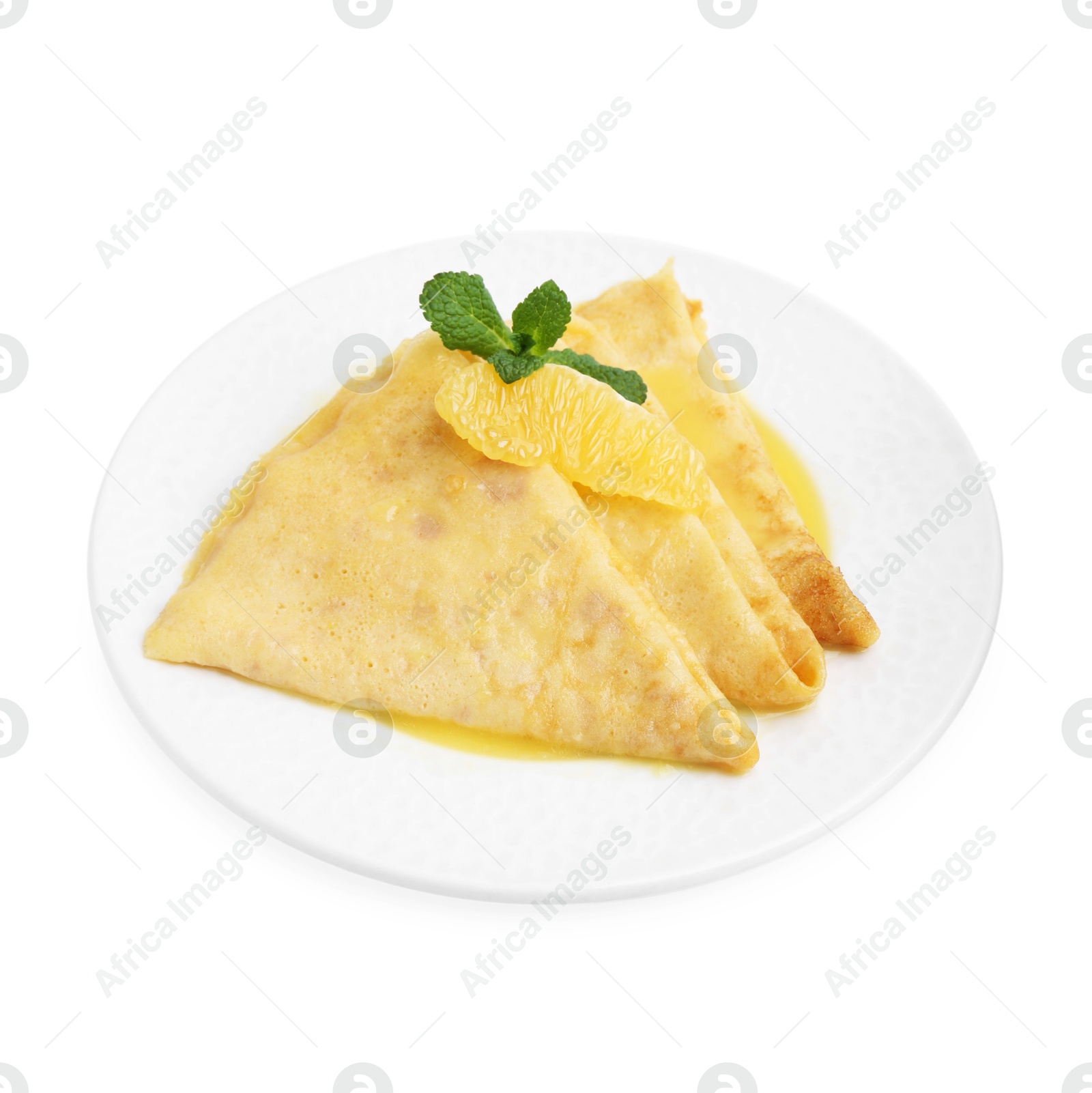 Photo of Plate with tasty crepes Suzette isolated on white