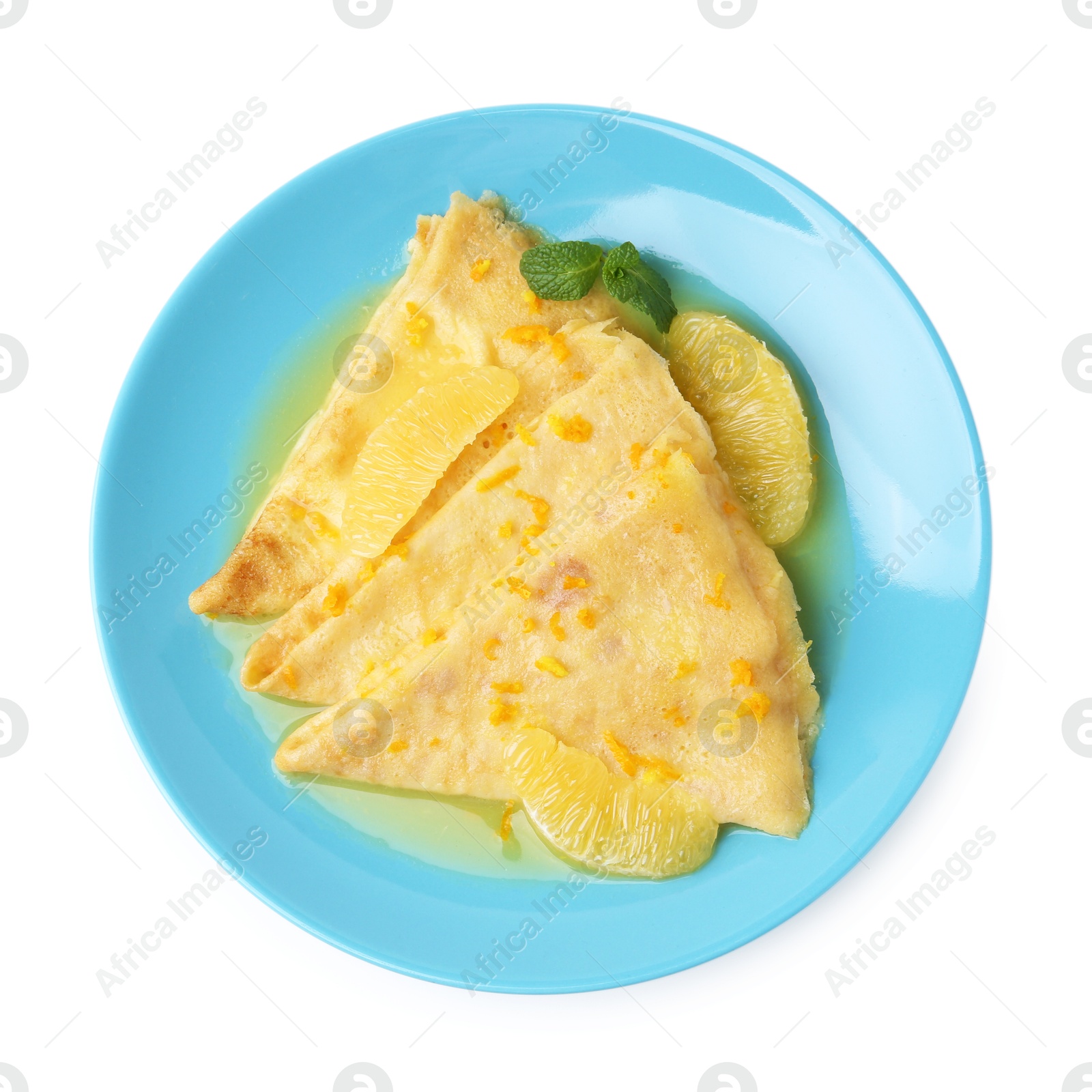 Photo of Plate with tasty crepes Suzette isolated on white, top view