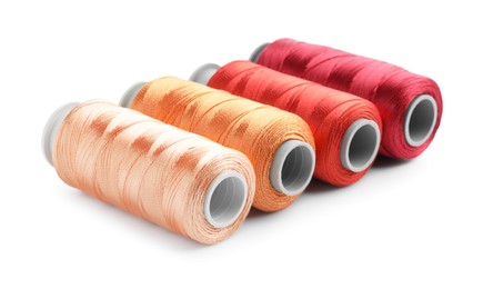 Photo of Spools of colorful sewing threads isolated on white