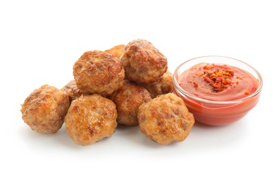 Photo of Pile of delicious meatballs and bowl with ketchup isolated on white