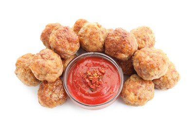 Photo of Pile of delicious meatballs and bowl with ketchup isolated on white, above view