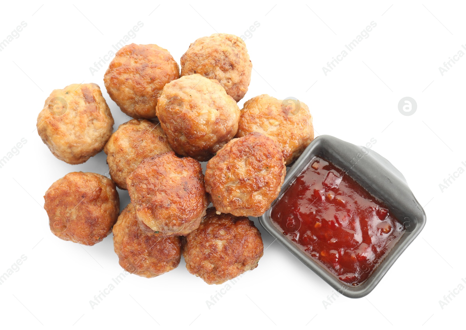 Photo of Pile of delicious meatballs and bowl with ketchup isolated on white, top view