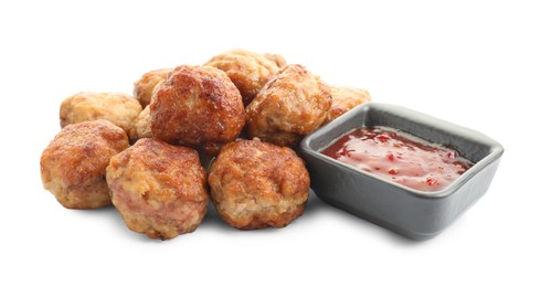 Photo of Pile of delicious meatballs and bowl with ketchup isolated on white