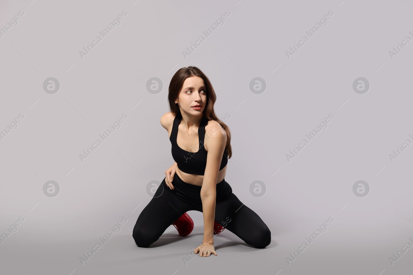 Photo of Beautiful woman in stylish sportswear on grey background