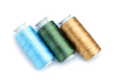 Photo of Spools of bright sewing threads isolated on white, top view