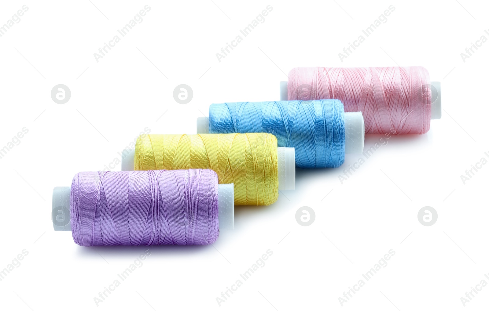 Photo of Spools of bright sewing threads isolated on white