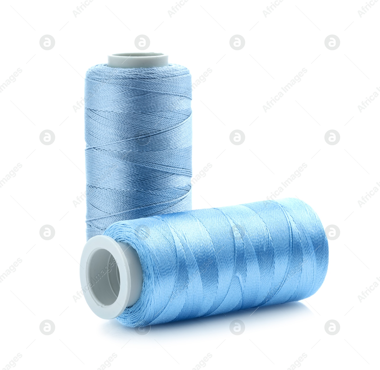 Photo of Spools of bright sewing threads isolated on white