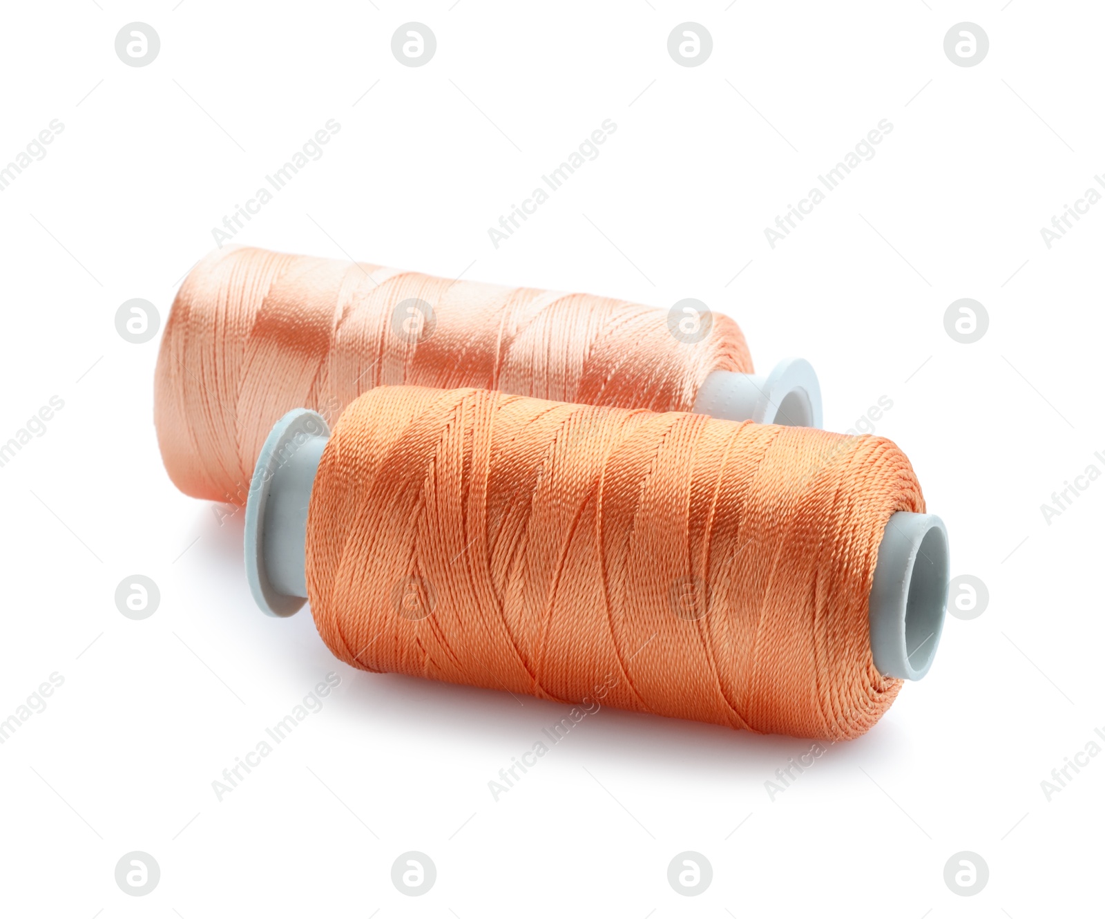 Photo of Spools of bright sewing threads isolated on white