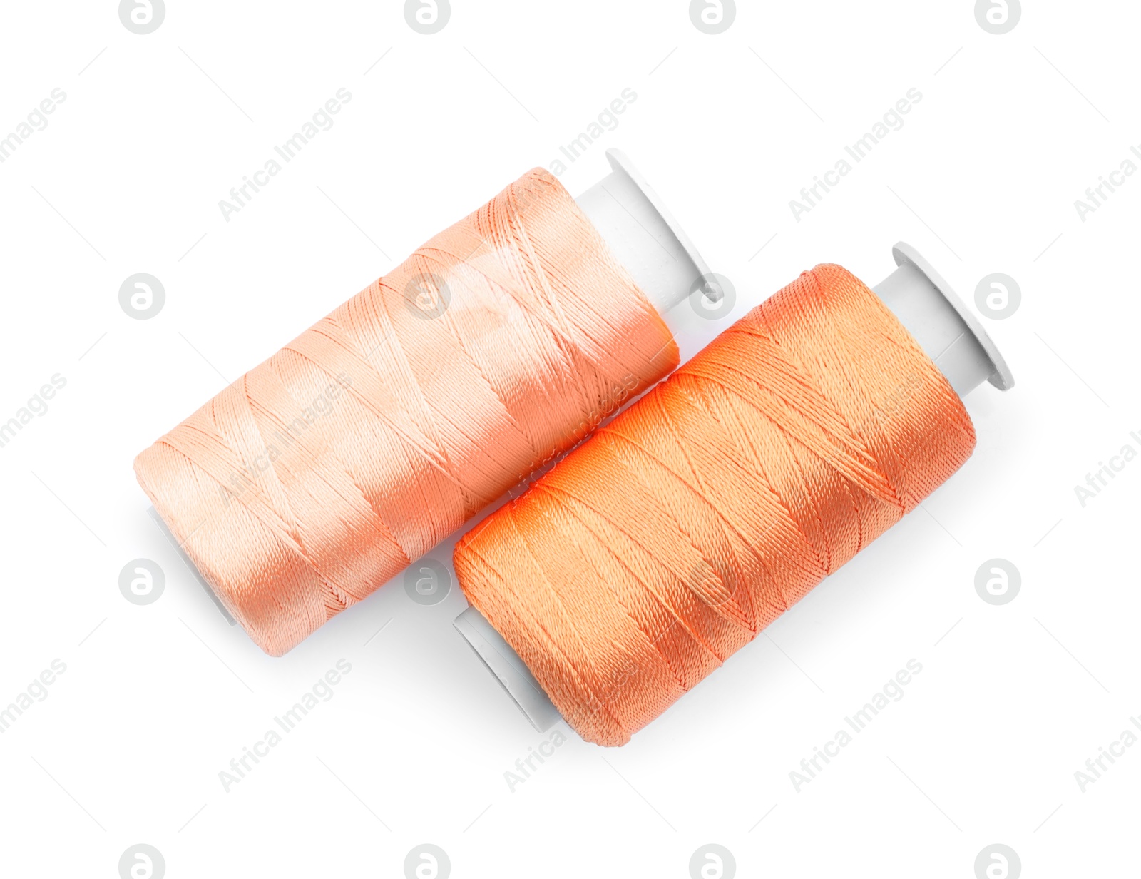 Photo of Spools of bright sewing threads isolated on white, top view