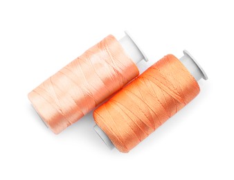 Photo of Spools of bright sewing threads isolated on white, top view