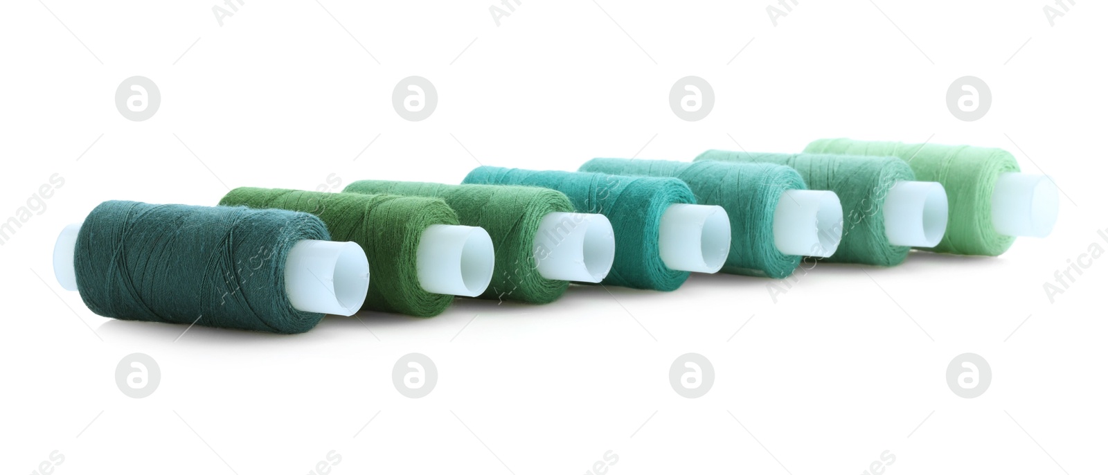 Photo of Spools of bright sewing threads isolated on white