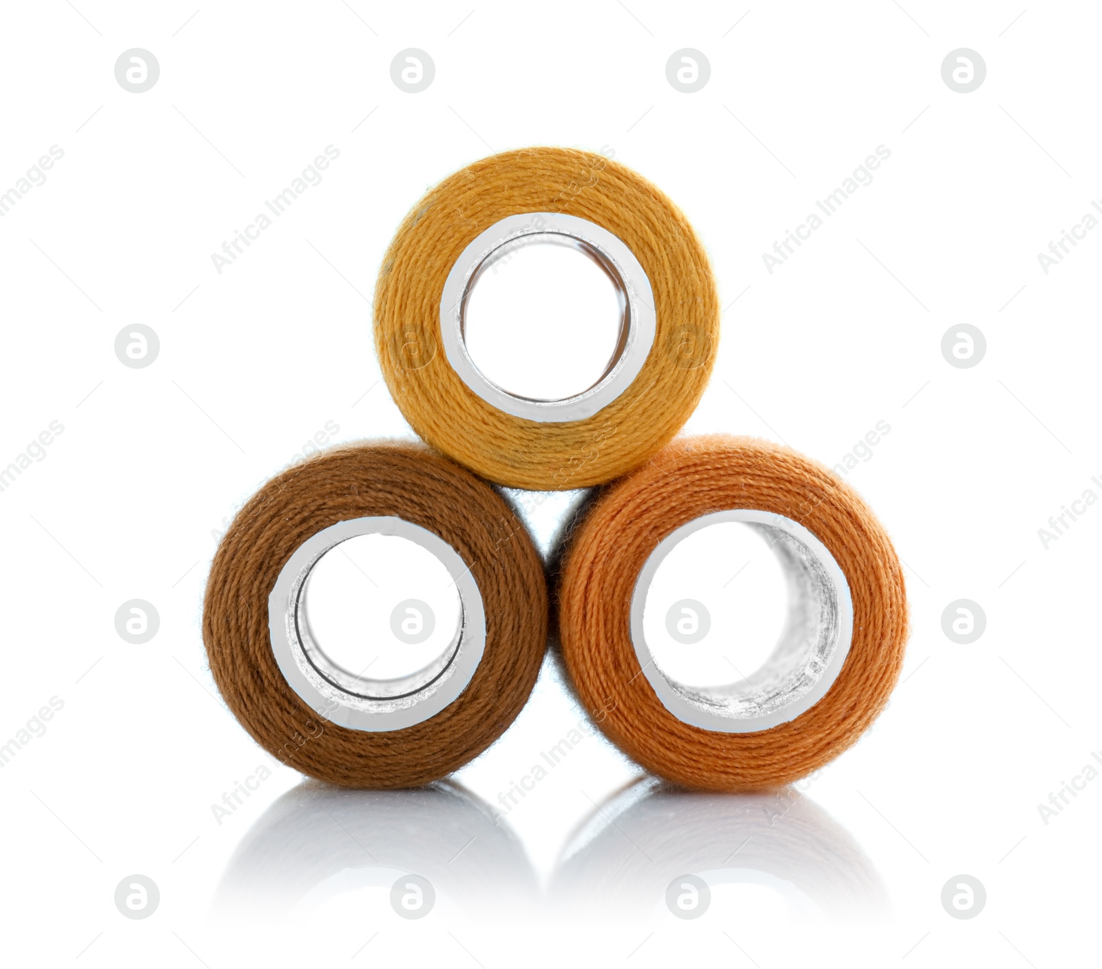 Photo of Spools of bright sewing threads isolated on white