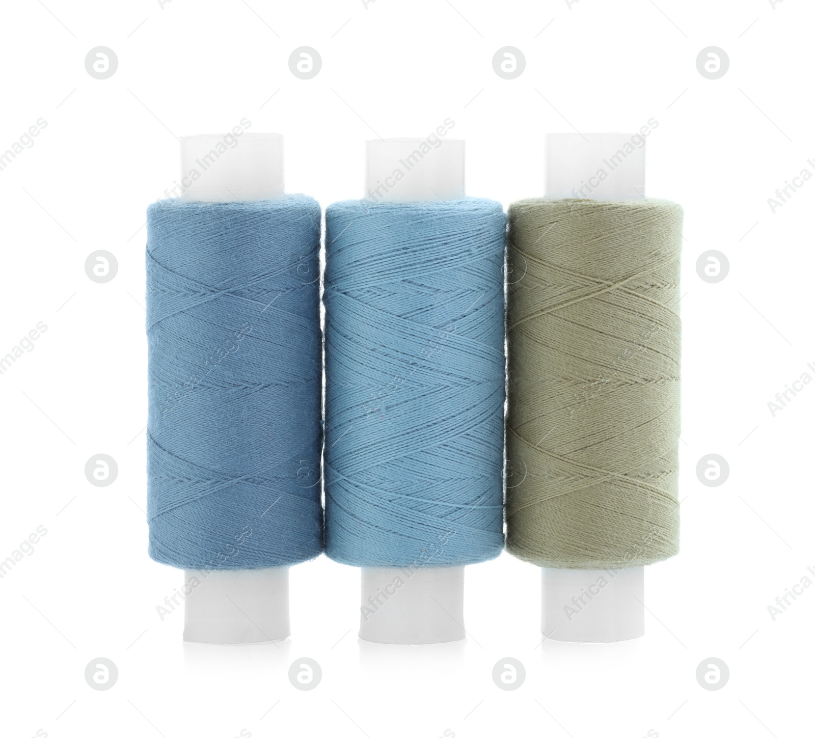 Photo of Spools of bright sewing threads isolated on white