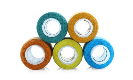 Photo of Spools of bright sewing threads isolated on white