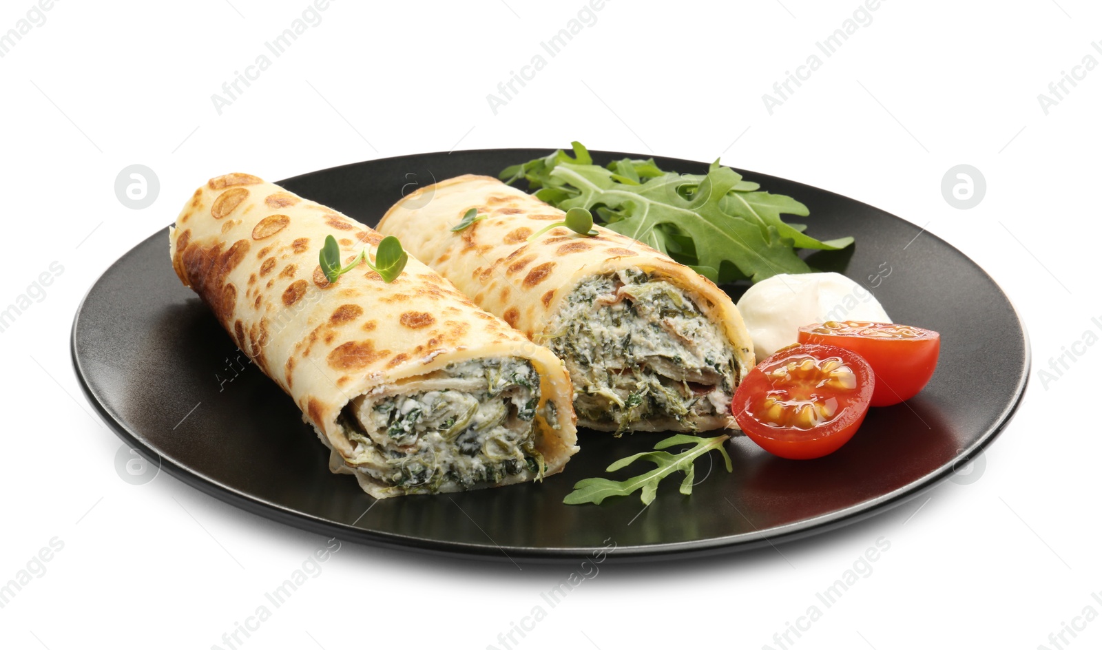 Photo of Tasty rolled crepes with cottage cheese, spinach, arugula and tomato isolated on white