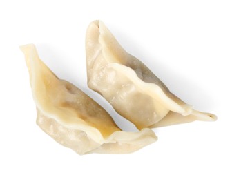 Photo of Tasty boiled gyoza (dumplings) isolated on white, top view