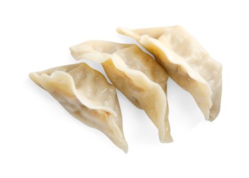 Photo of Tasty boiled gyoza (dumplings) isolated on white, top view