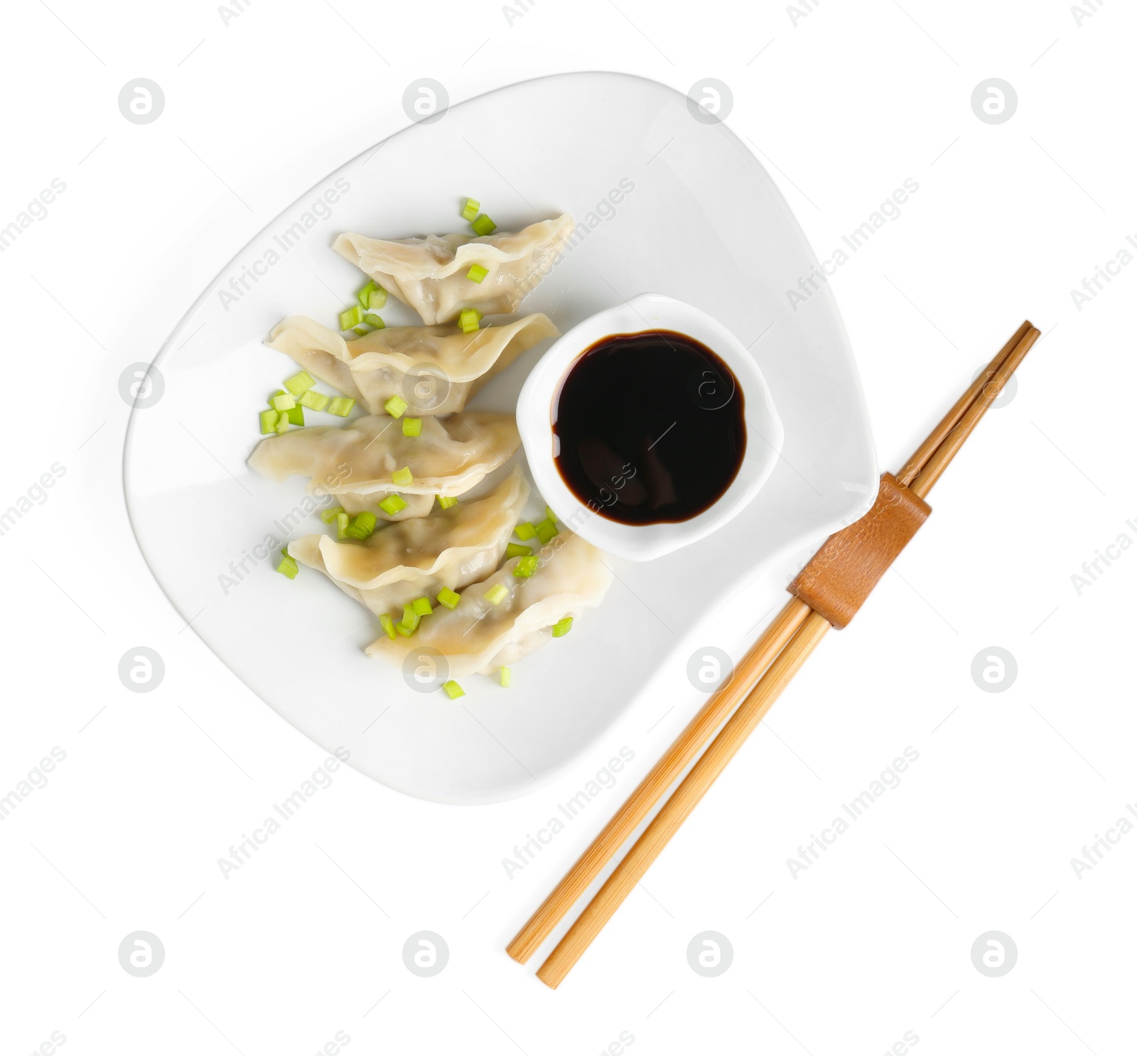 Photo of Tasty gyoza (dumplings), soy sauce and chopsticks isolated on white, top view