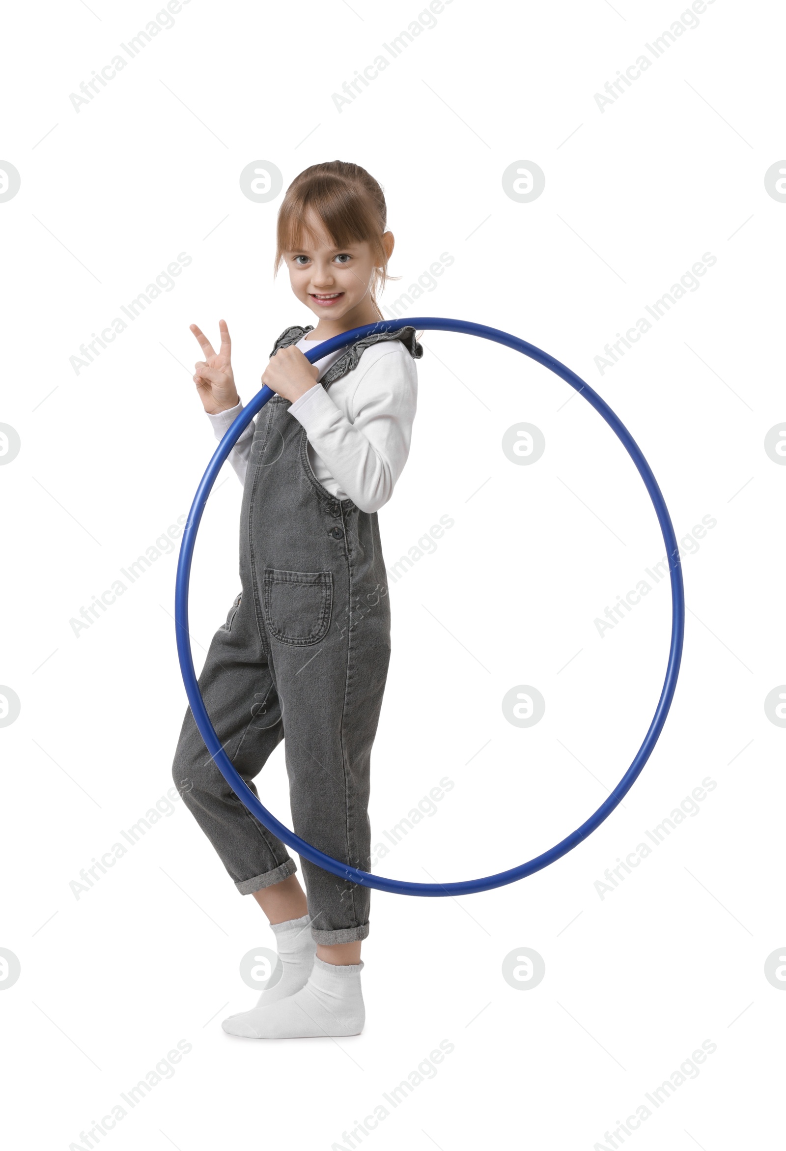 Photo of Cute little girl with hula hoop showing V-sign on white background