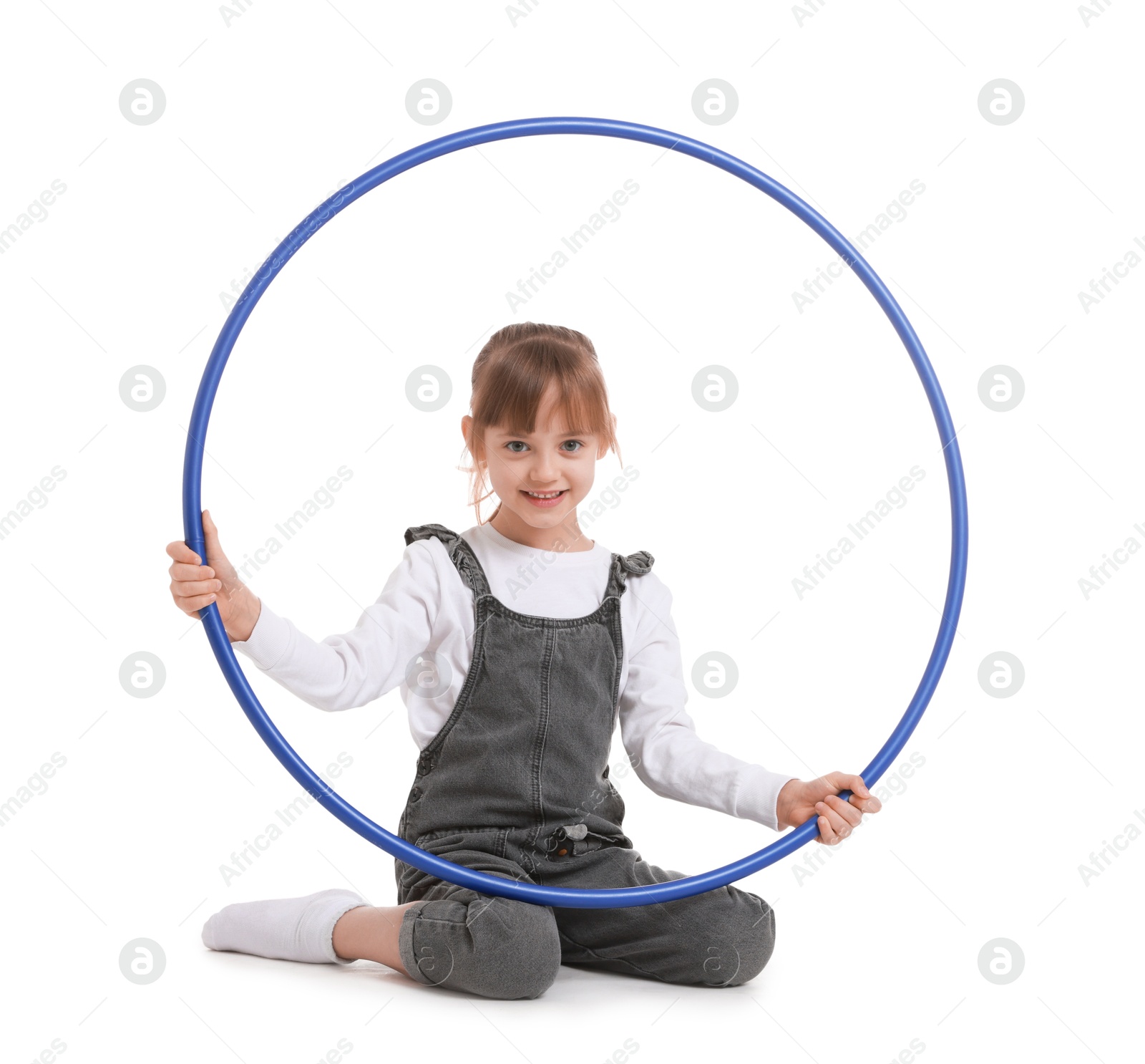 Photo of Cute little girl with hula hoop on white background