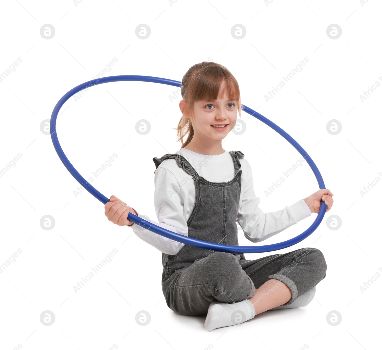 Photo of Cute little girl with hula hoop on white background