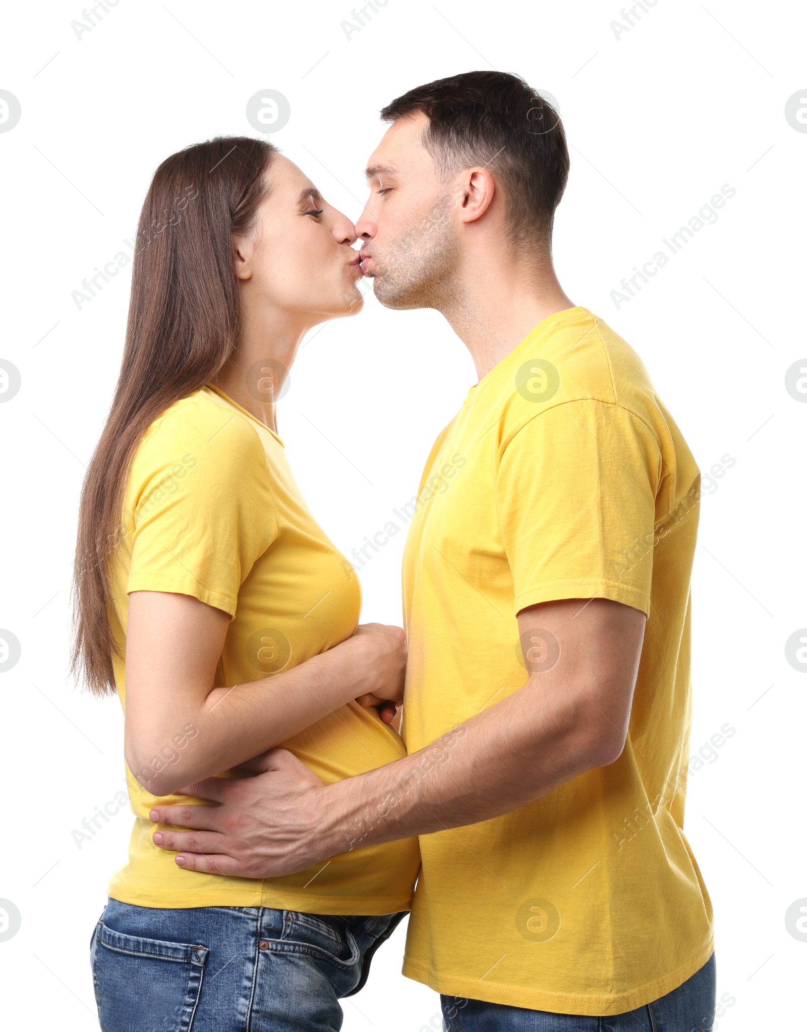 Photo of Pregnant woman and her husband kissing on white background