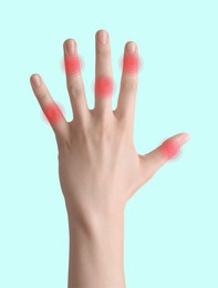 Image of Woman with joint inflammation on light blue background, closeup. Red areas on fingers