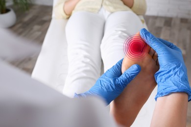 Image of Joint inflammation. Doctor checking woman's foot at hospital, closeup