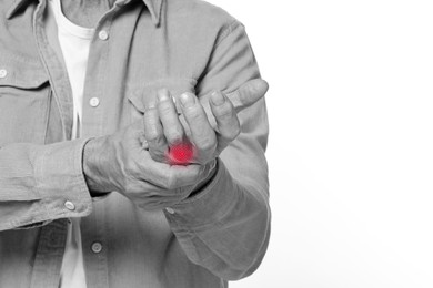 Image of Man with joint inflammation on white background, closeup. Toned in black-and-white with color area on finger