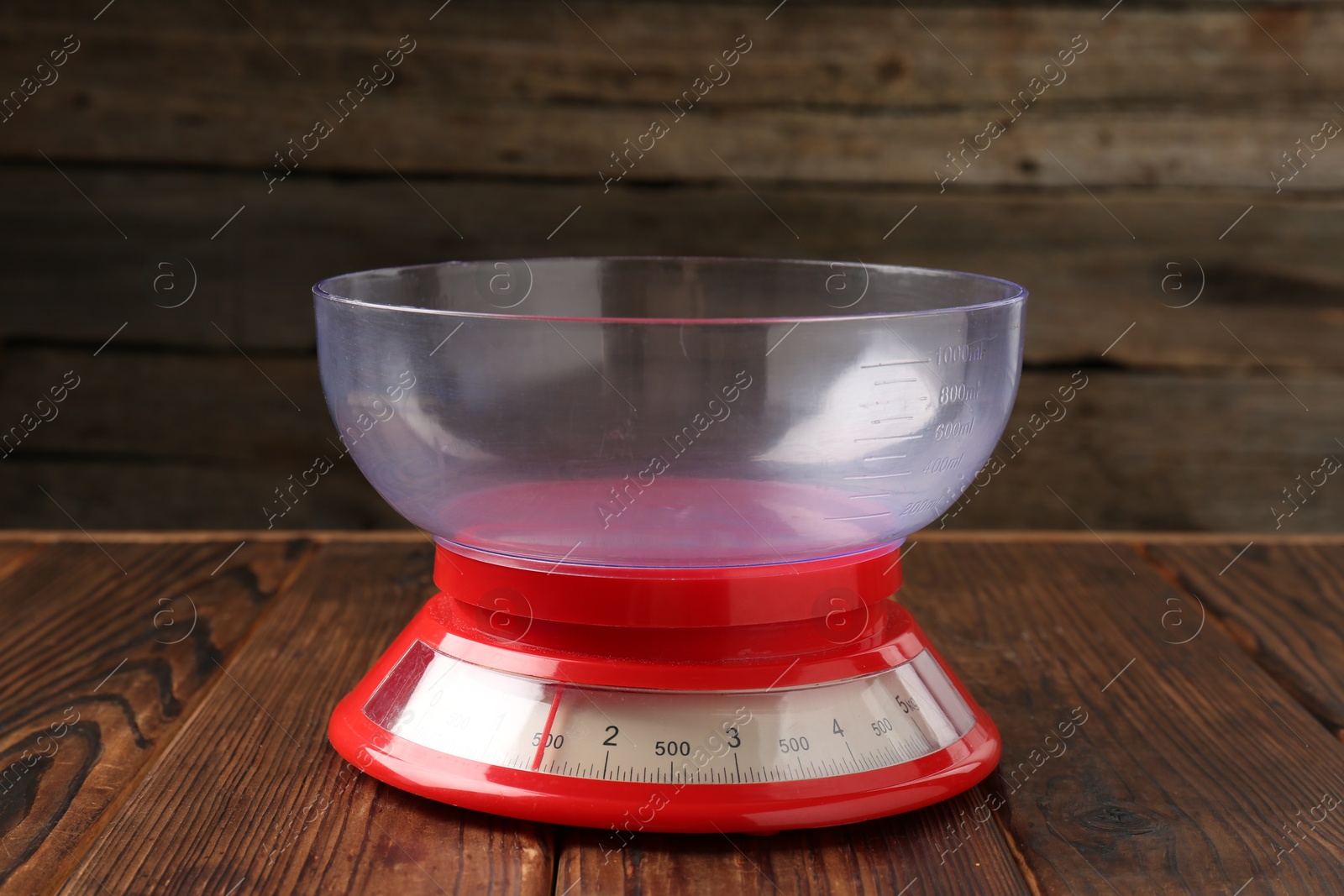 Photo of One kitchen scale on wooden table, closeup