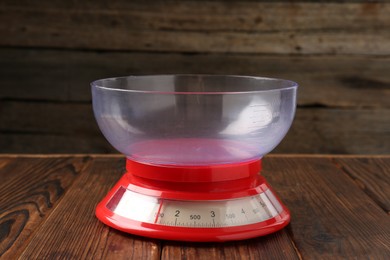 Photo of One kitchen scale on wooden table, closeup