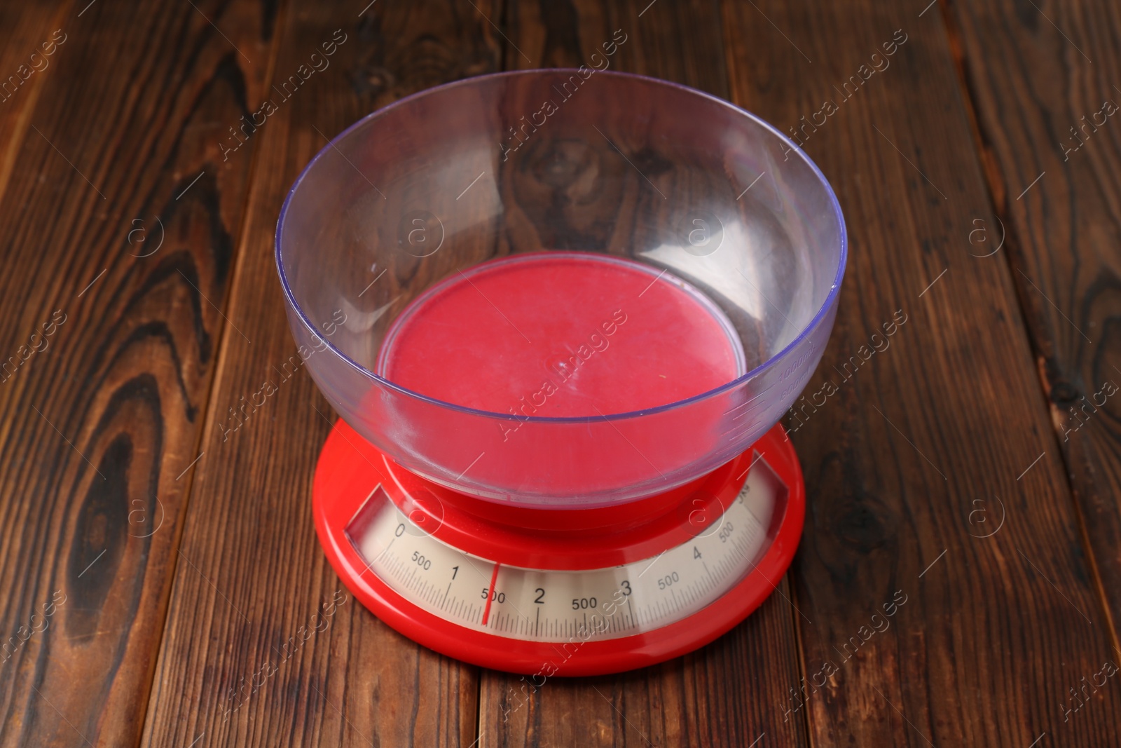 Photo of One kitchen scale on wooden table, closeup