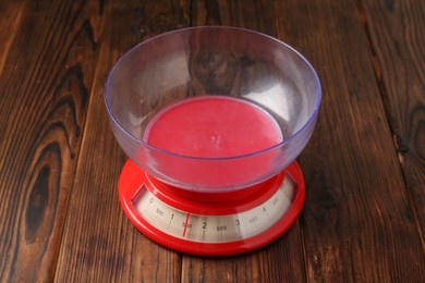 Photo of One kitchen scale on wooden table, closeup