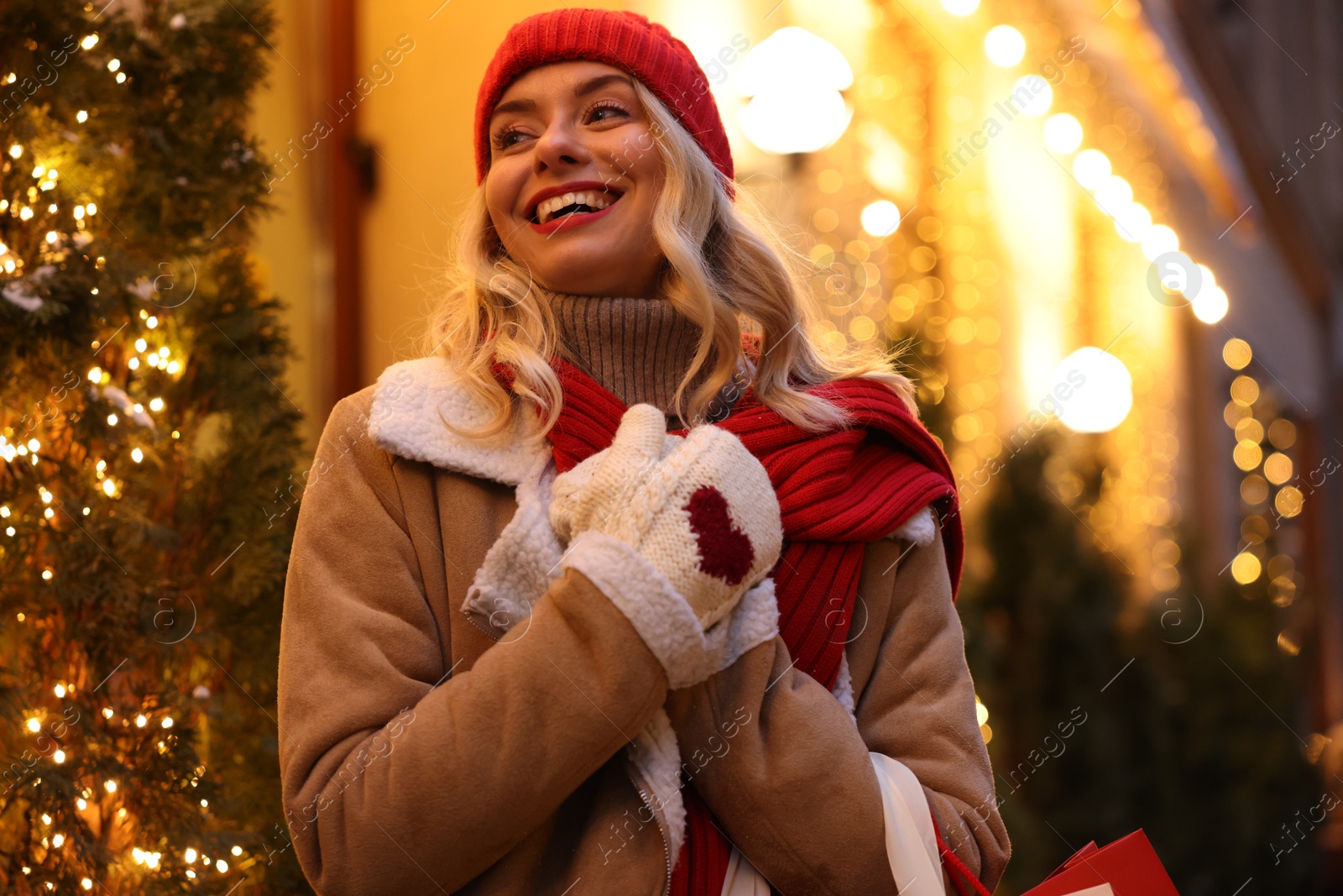 Photo of Portrait of happy woman on city street. Christmas season