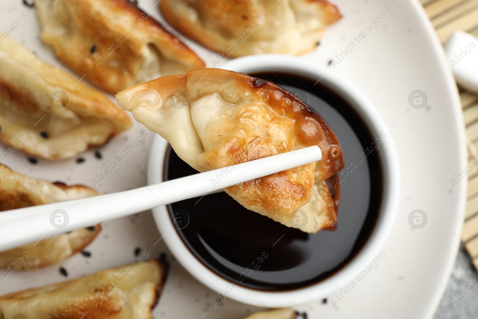 Photo of Eating fried gyoza dumplings at table, closeup