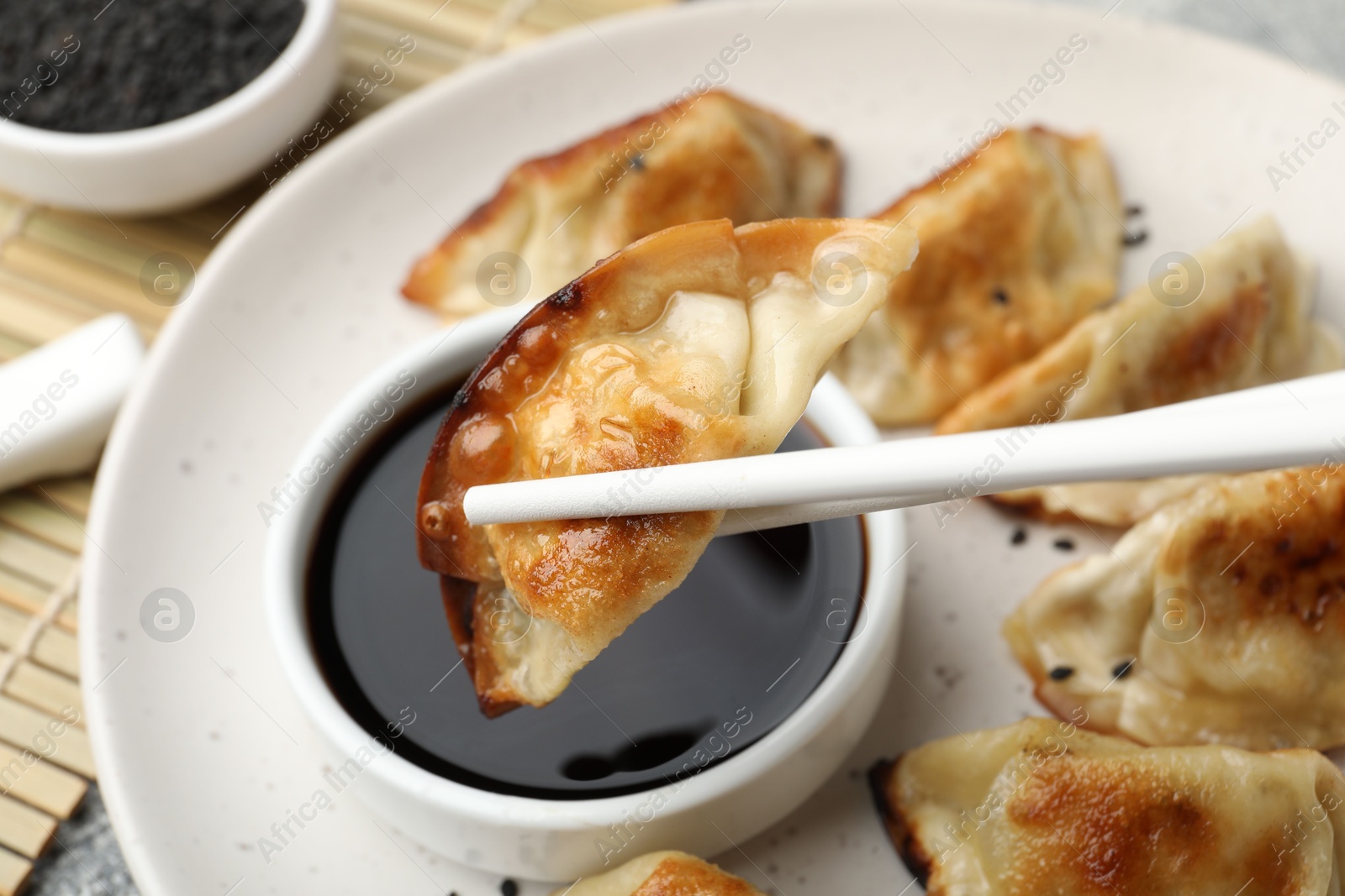 Photo of Eating fried gyoza dumplings at table, closeup