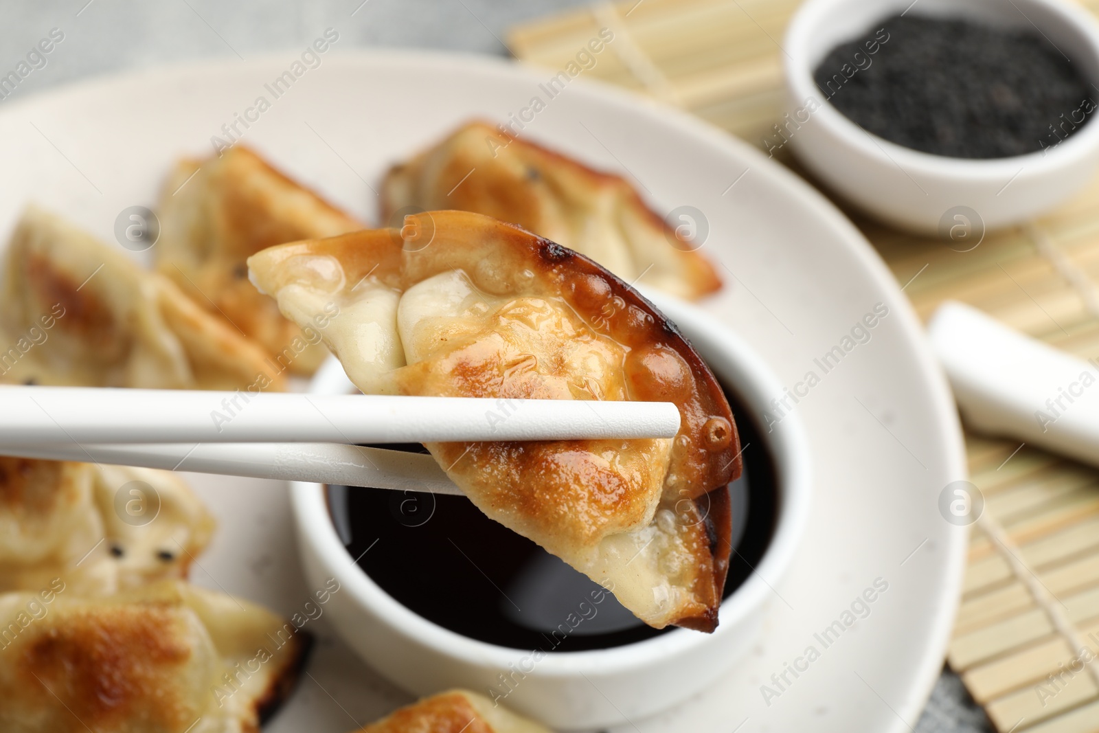 Photo of Eating fried gyoza dumplings at table, closeup