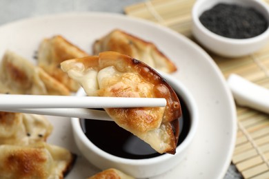 Photo of Eating fried gyoza dumplings at table, closeup