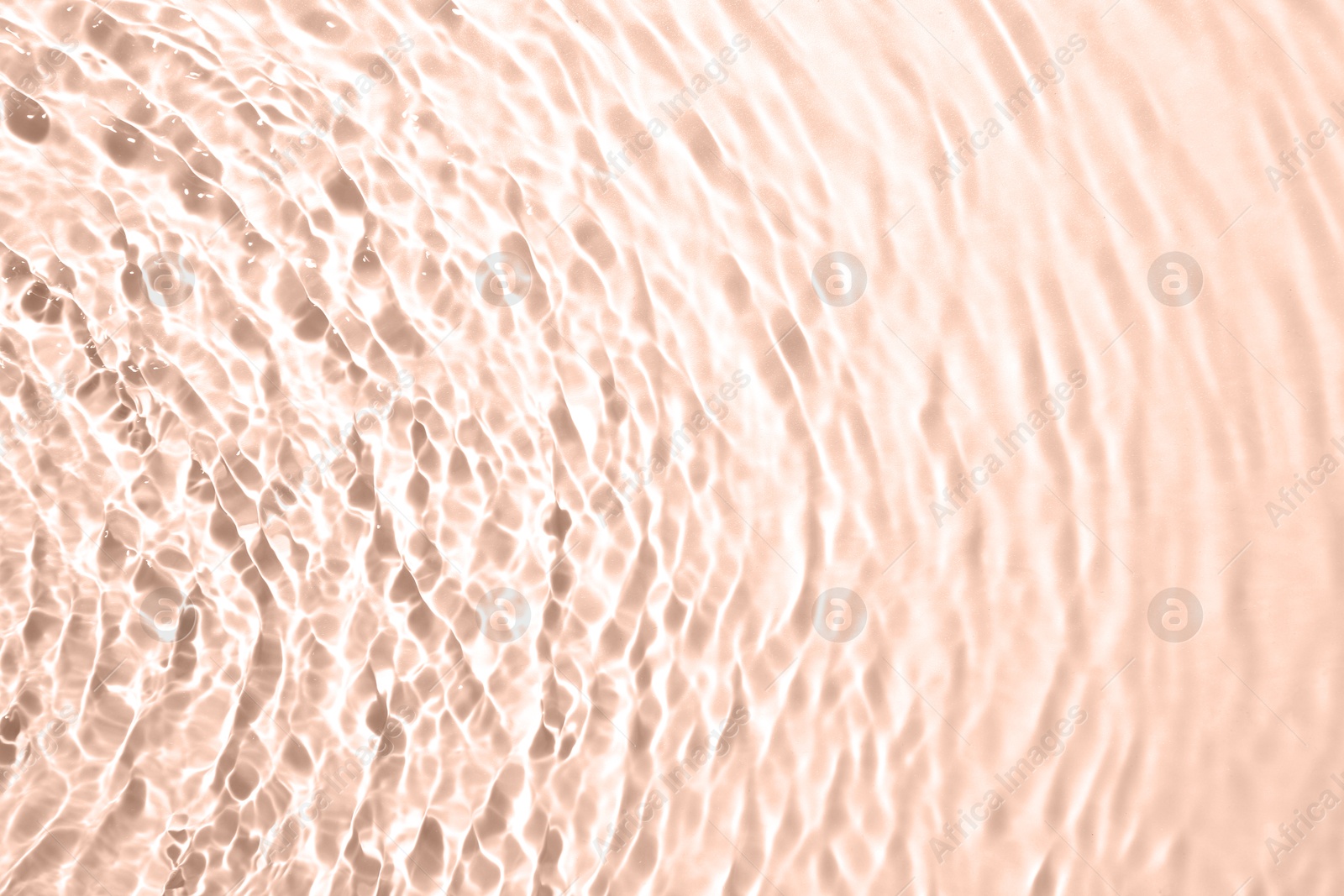 Image of Rippled surface of clear water on beige background, top view. Mocha mousse - color of 2025 year