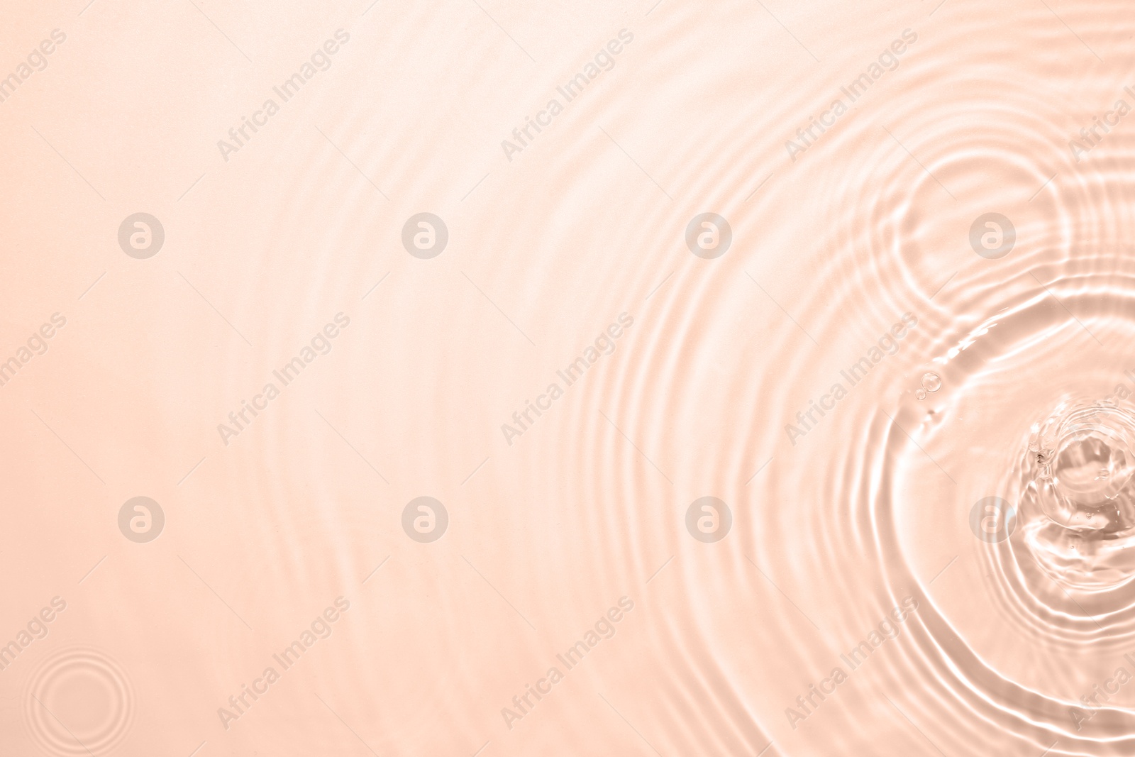 Image of Rippled surface of clear water on beige background, top view. Mocha mousse - color of 2025 year