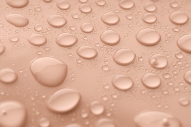 Image of Beige shade surface with water drops, closeup. Mocha mousse - color of 2025 year