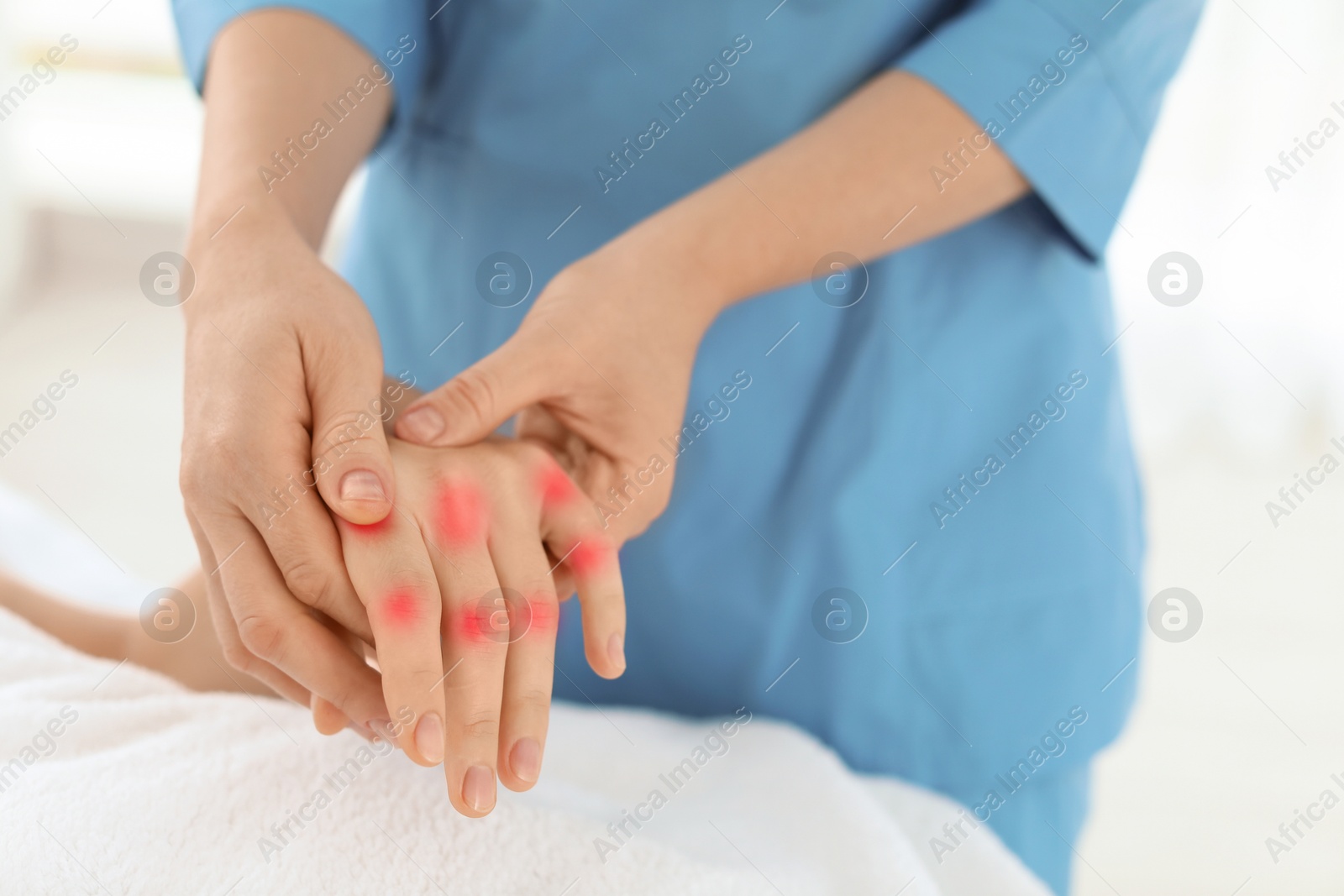 Image of Woman with joint inflammation receiving hand massage in wellness center, closeup