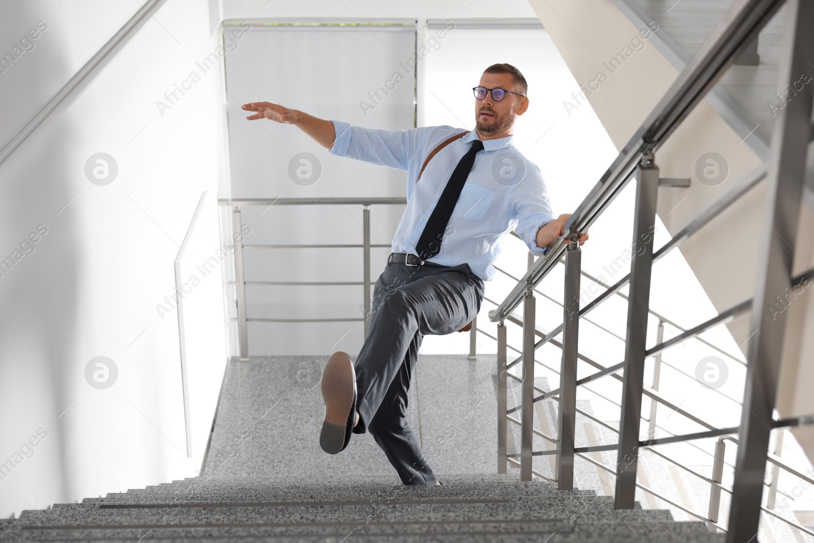 Photo of Man falling on stairs in building. Dangerous accident