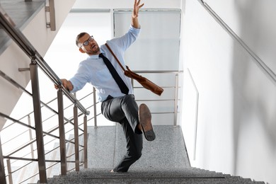 Photo of Man falling on stairs in building. Dangerous accident