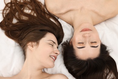 Photo of Spa day. Happy women lying on bed, above view